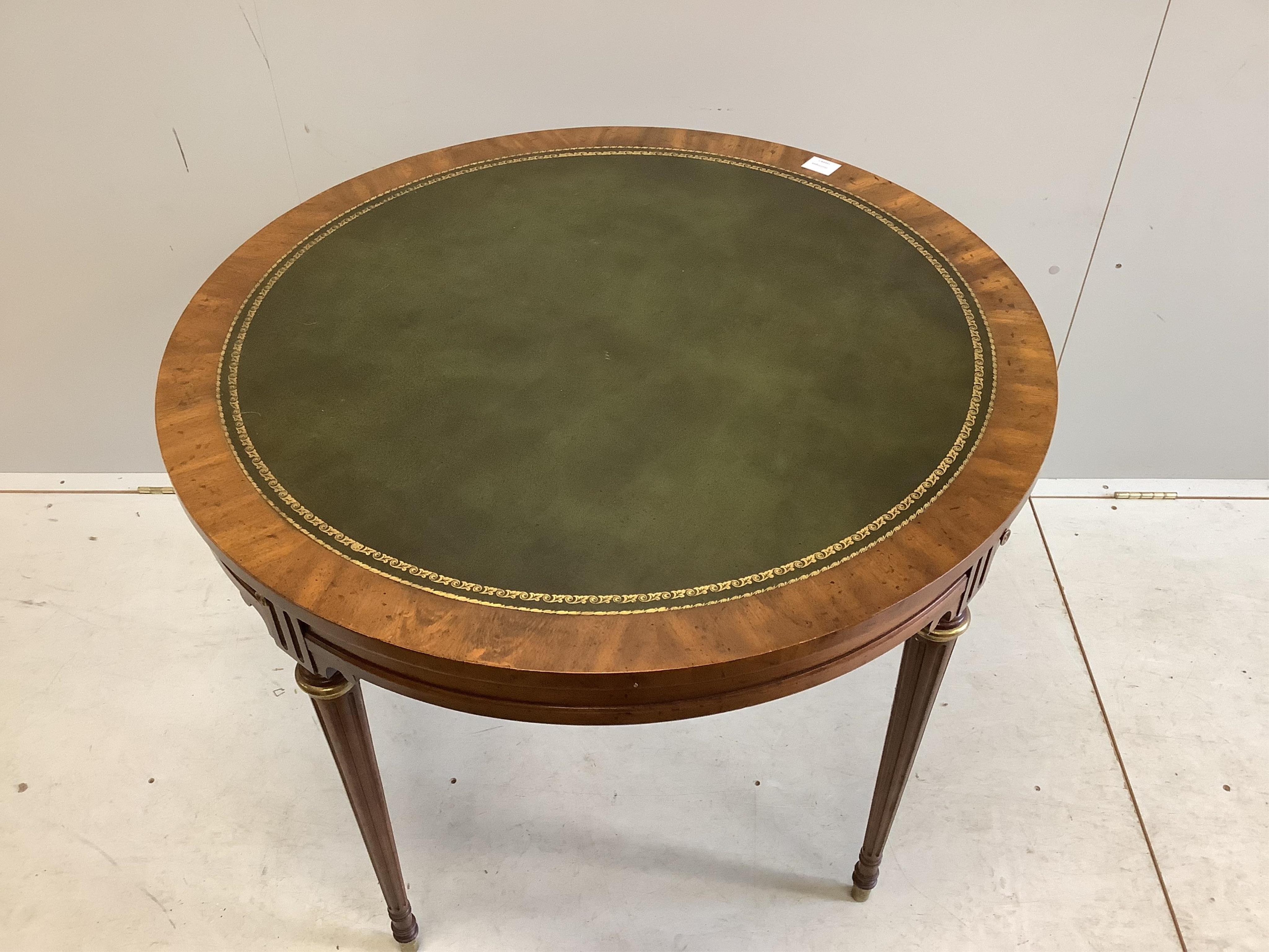 An Empire style circular mahogany games table, diameter 92cm, height 74cm and four caned chairs. Condition - fair to good